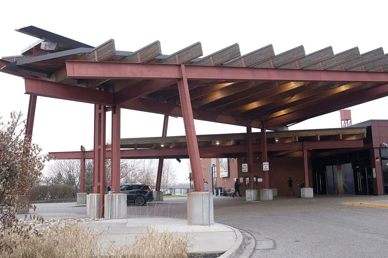 The timber-and-steel entrance canopy of Casino Ajax over the drop-off loop